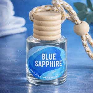 Blue Sapphire hanging car diffuser with glass bottle, wooden cap, and braided rope on blue background