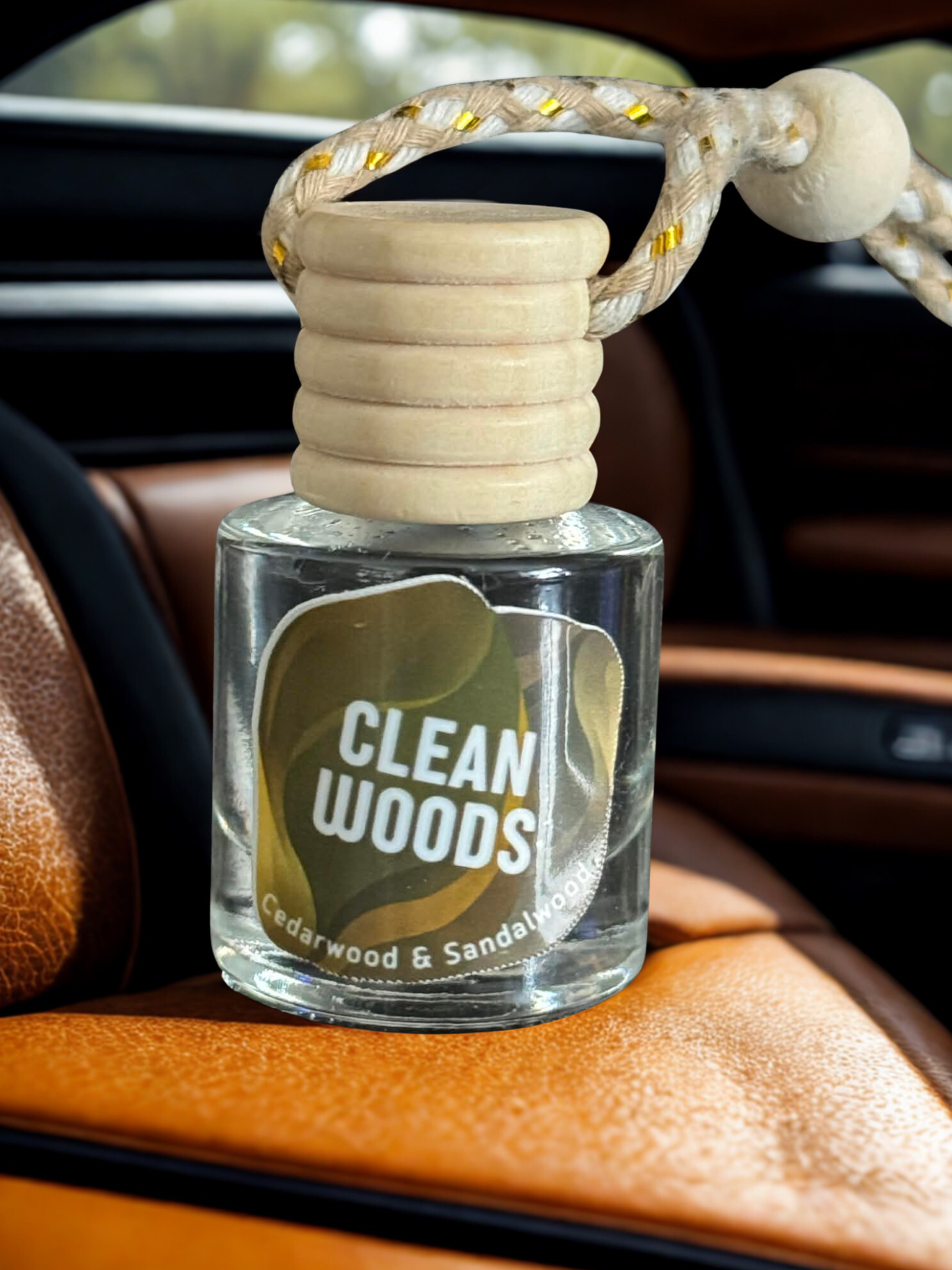 Close-up of glass car air freshener with wooden cap and braided rope on leather seat