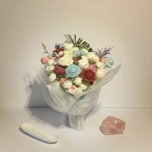 Handmade candle flower bouquet with pastel wax flowers arranged like a real floral gift in soft neutral styling
